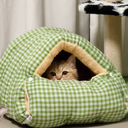 1. A gray cat peeks from a gingham cave pet bed, showcasing its secure, den-like design for warmth - vivaessencepet