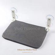 A ginger cat relaxing on a secure and stylish cat window perch hammock, enjoying a sunny view outside - vivaessencepet