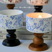 A handcrafted ceramic aromatherapy candle with a vintage floral pattern on its glazed, artisanal holder by vivaessencepet