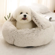 A small dog nestles in the Snuggle Haven Deluxe Pet Bed, its hooded design offering a calm sanctuary - vivaessencepet