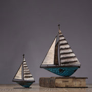 1. A beautifully handcrafted wooden sailboat model, showcasing its detailed craftsmanship and crisp fabric sails. This ship model is a perfect nautical decor accent by vivaessencepet