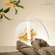 Artisan Osmanthus botanical wax sachet showing delicate flowers embedded in natural soy wax - vivaessencepet