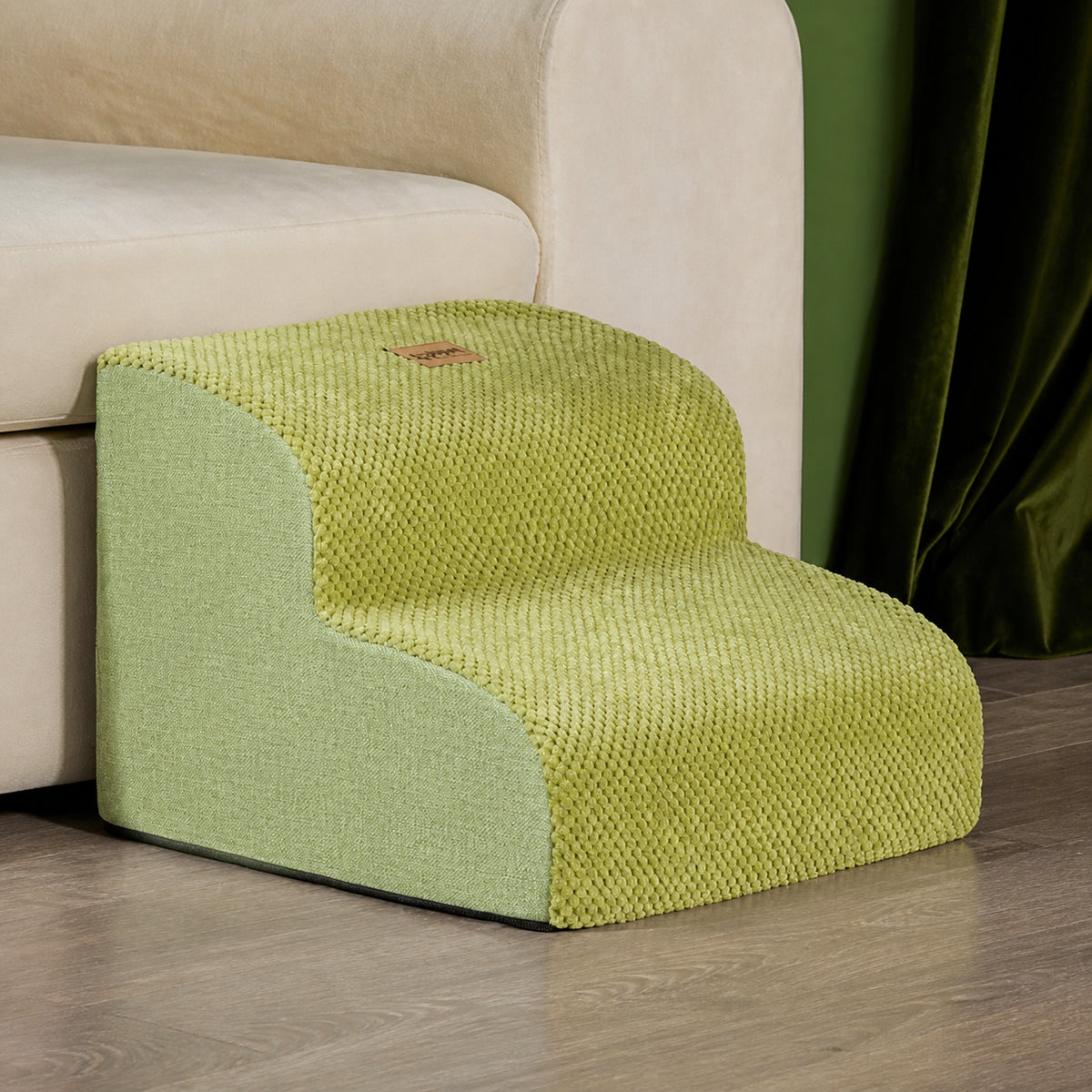 Green two-step non-slip dog stairs in a cream-sofa living-room scene.