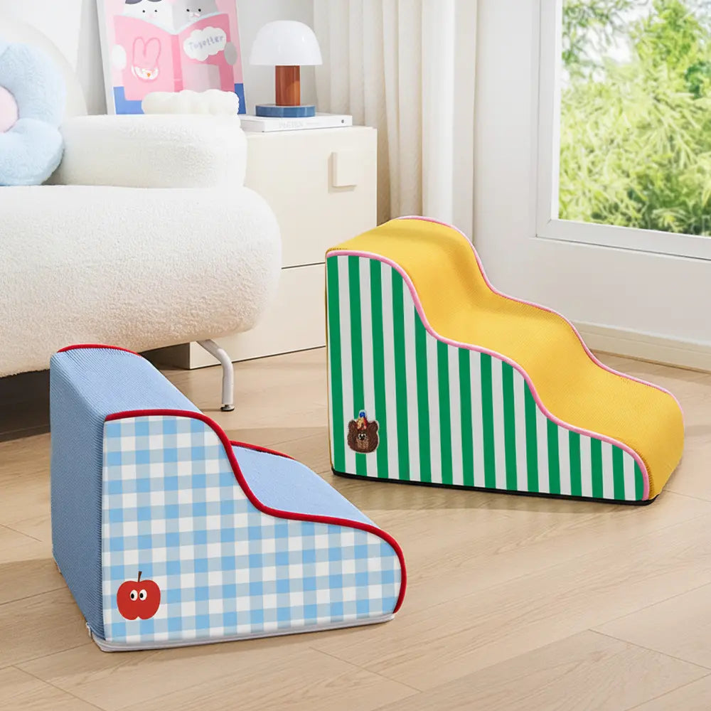 Blue two-step and yellow three-step soft dog stairs displayed beside a sofa