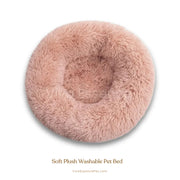 A fluffy white cat sleeping soundly in a plush, light gray calming donut pet bed - vivaessencepet