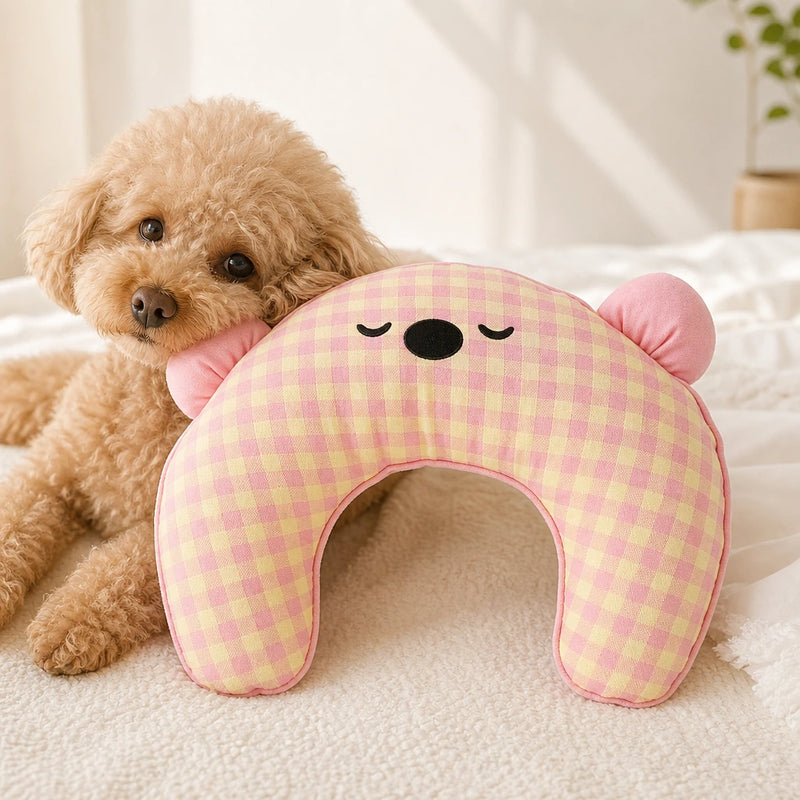 Small tan dog beside a pink gingham Cuddle Cloud pet pillow