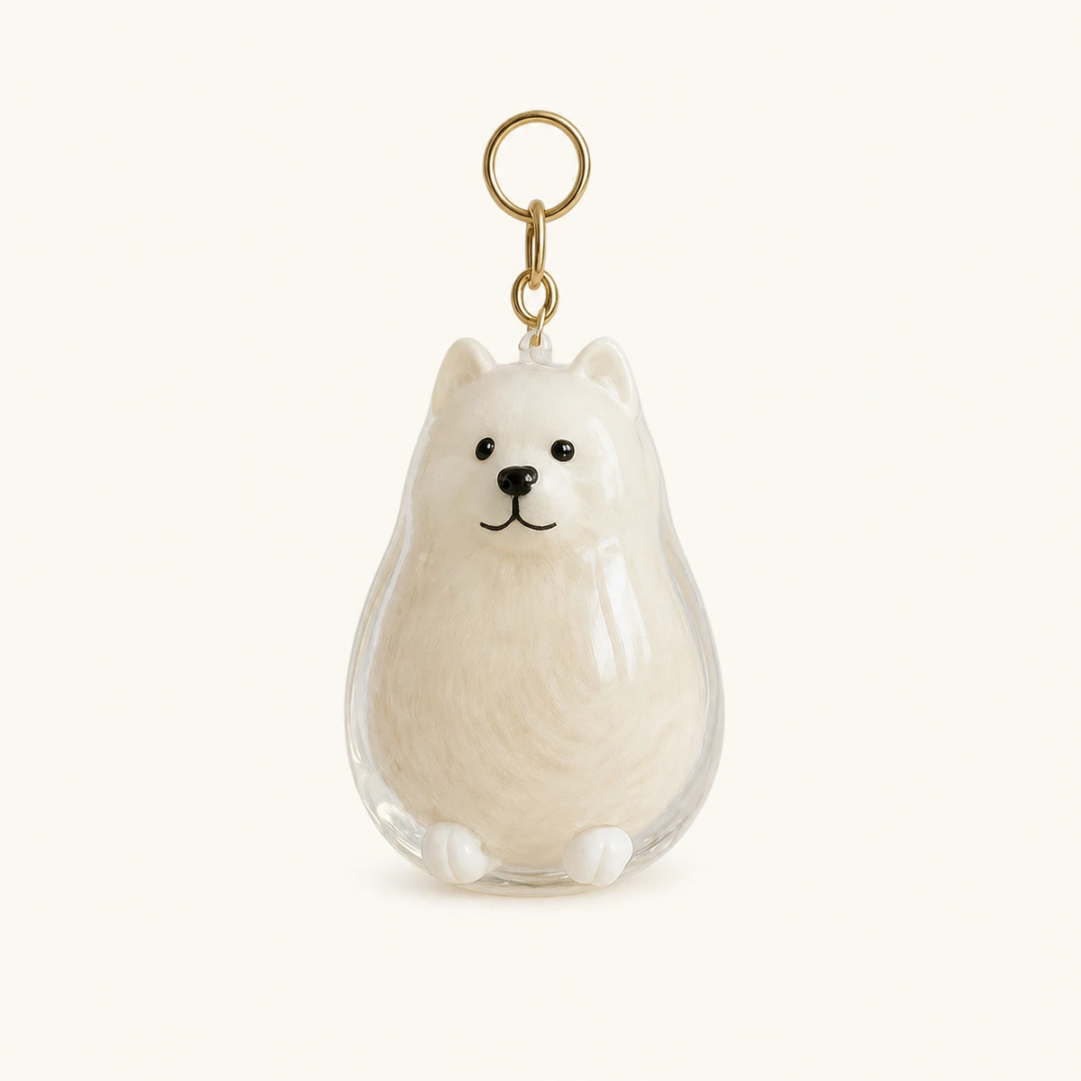 Lieve samojeed als herinneringssleutelhanger met dierenhaar en een doorzichtige capsule op een warme ivoorkleurige achtergrond