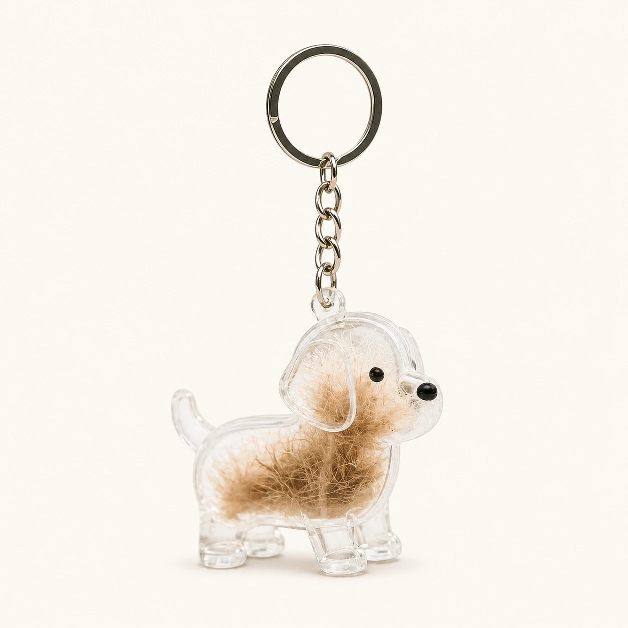 Transparent Puppy pet fur keepsake keychain with clear capsule on a warm ivory background