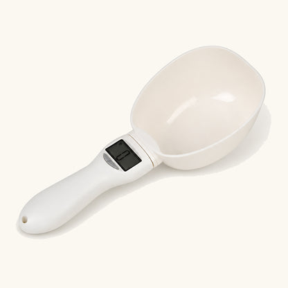 White digital pet food scoop shown empty with its LCD display
