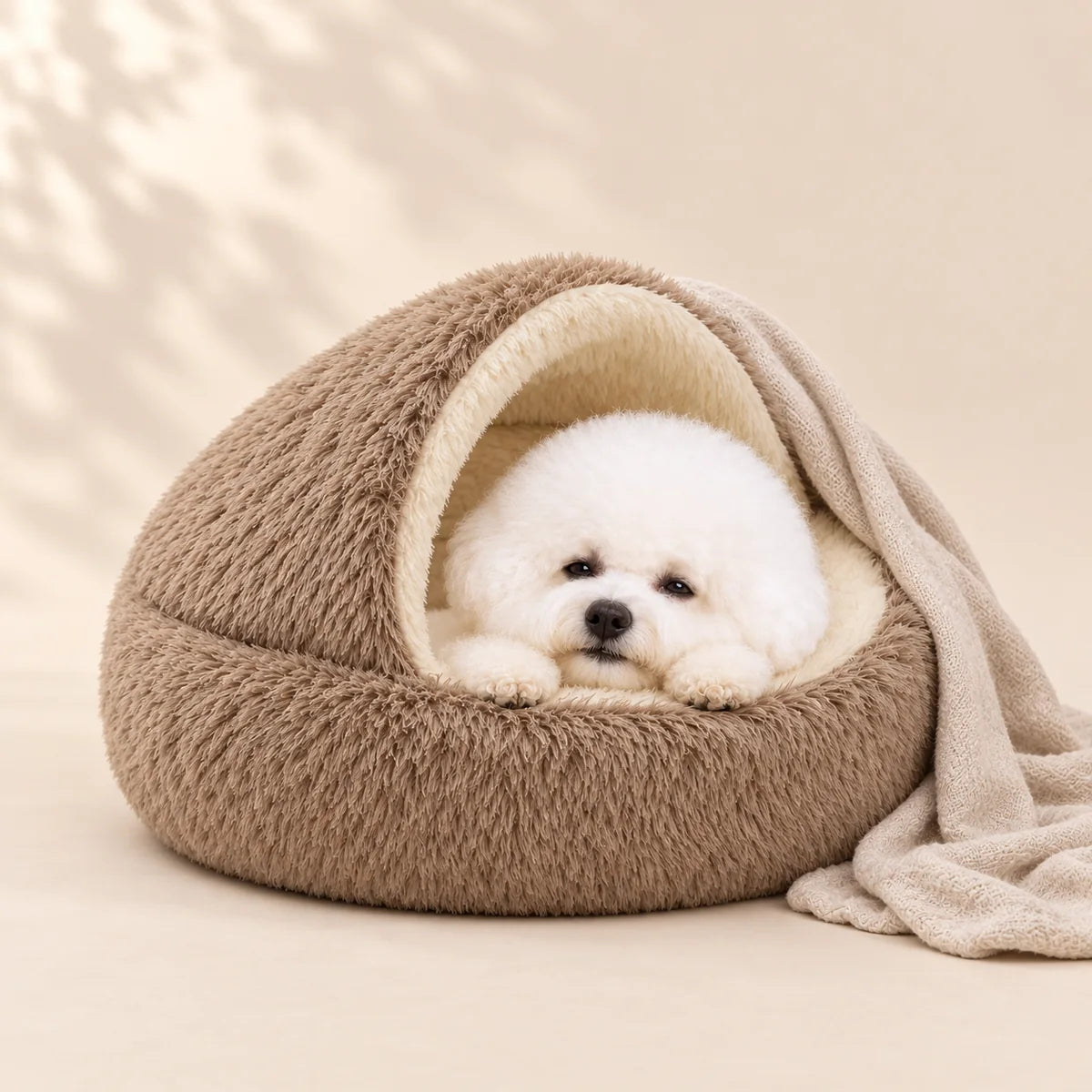 Small white dog sleeping in a plush pet bed in a warm premium home interior